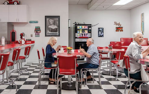 A restaurant with a red and black checkered floor. Description generated by AI