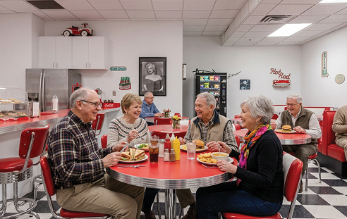 A restaurant with a red and black checkered floor. Description generated by AI