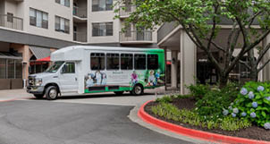 A white bus is parked in front of a building. AI generated content